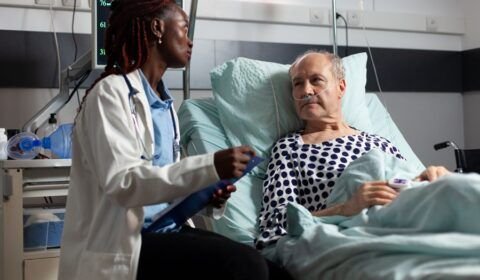 african-american-doctor-reading-diagnosis-from-clipboard