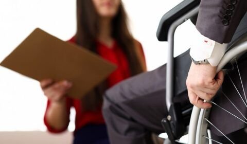 man-in-suit-on-wheelchair-communicates-with-woman