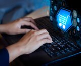 double-exposure-shopping-cart-businesswoman-using-laptop